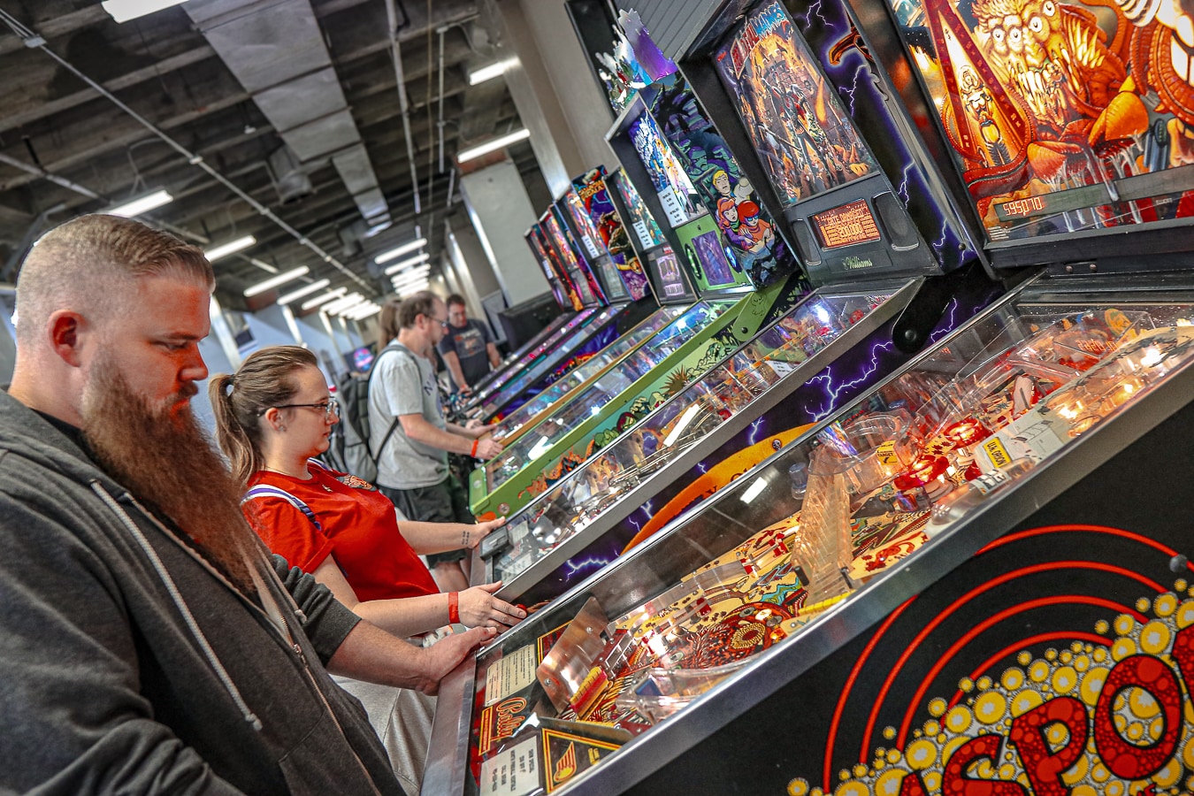 Guests play physical pinball machines